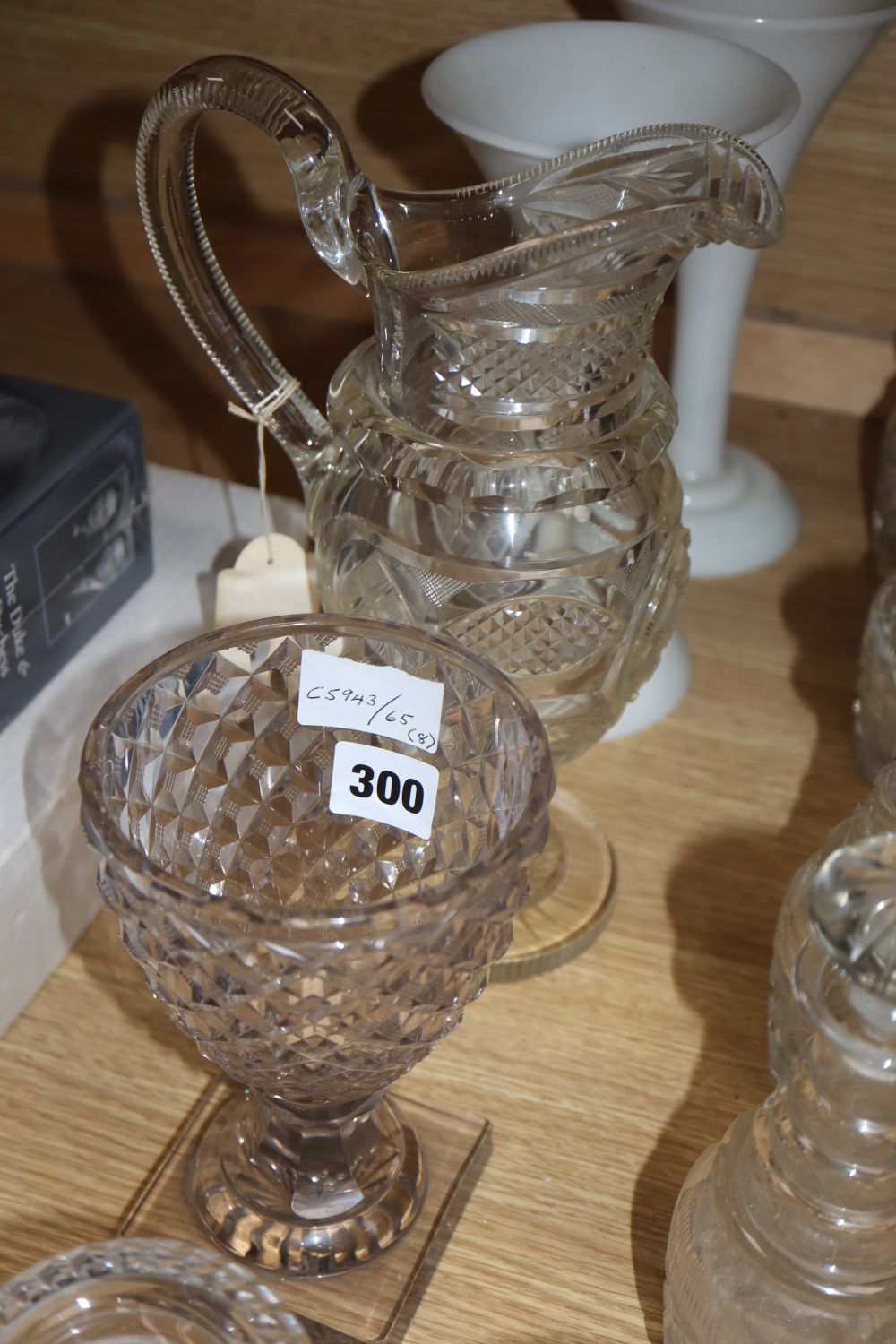 A quantity of 19th century cut glass including a set of four small decanters, together with a pair of opaque white glass vases